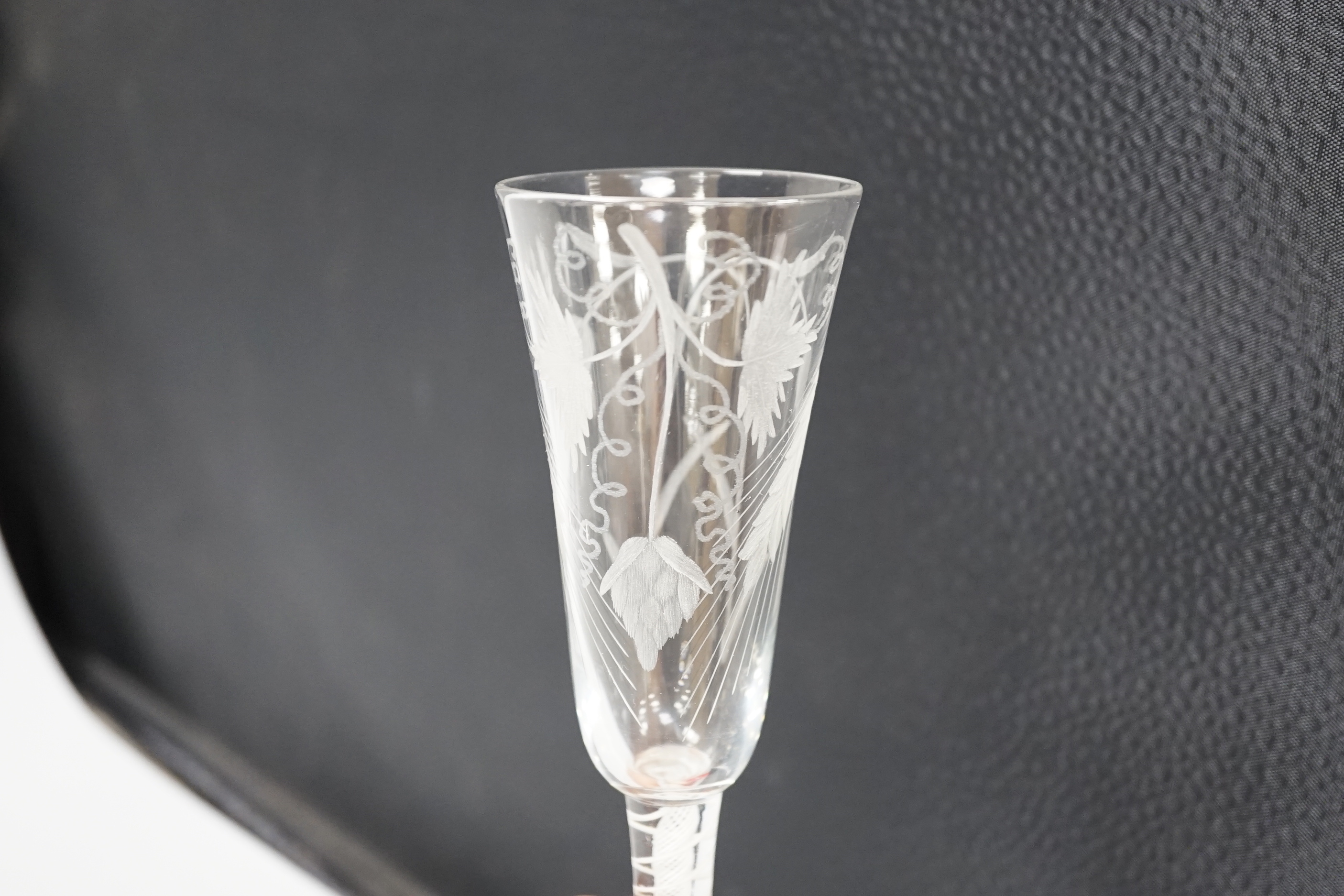 An English lead crystal DSOT ale glass, c.1760, elongated round funnel bowl finely engraved with hops and barley, DSOT stem, pair heavy tapes outside plain gauze, conical foot, snapped pontil, 18.8cm high